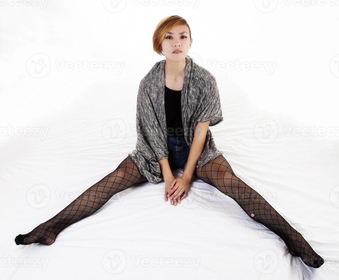 Attractive Asian American Woman Sitting Fishnet Stockings photo