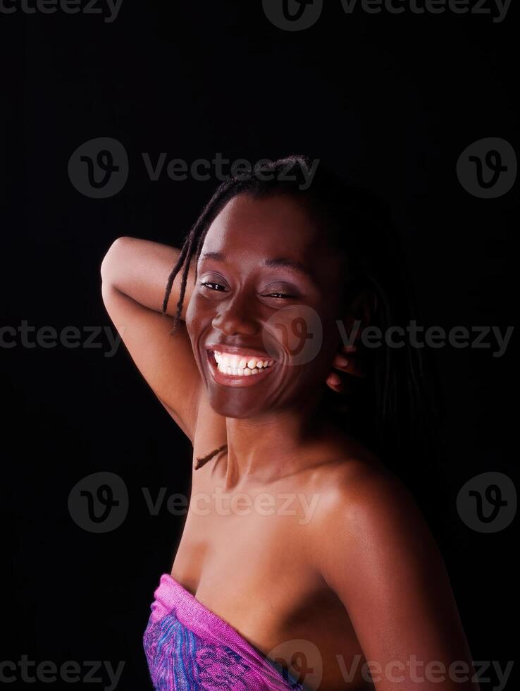 Smiling African American Woman Bare Sholder On Dark Background photo