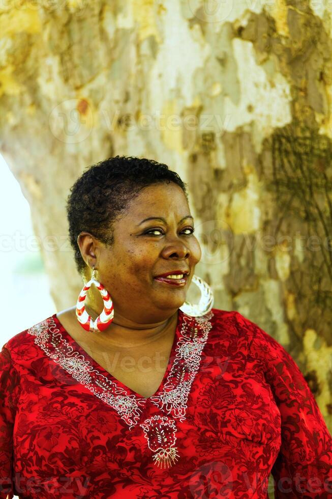 Middle Aged African American Woman Outdoor Portrait With Tree photo