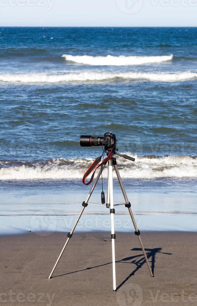 Digital SLR Camera On Tripod At The Ocean photo
