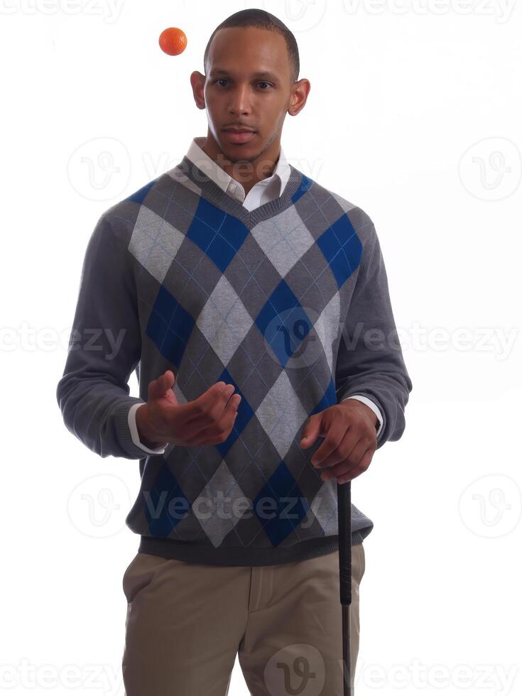 African American Man Tossing Up Golf Ball On White Background photo