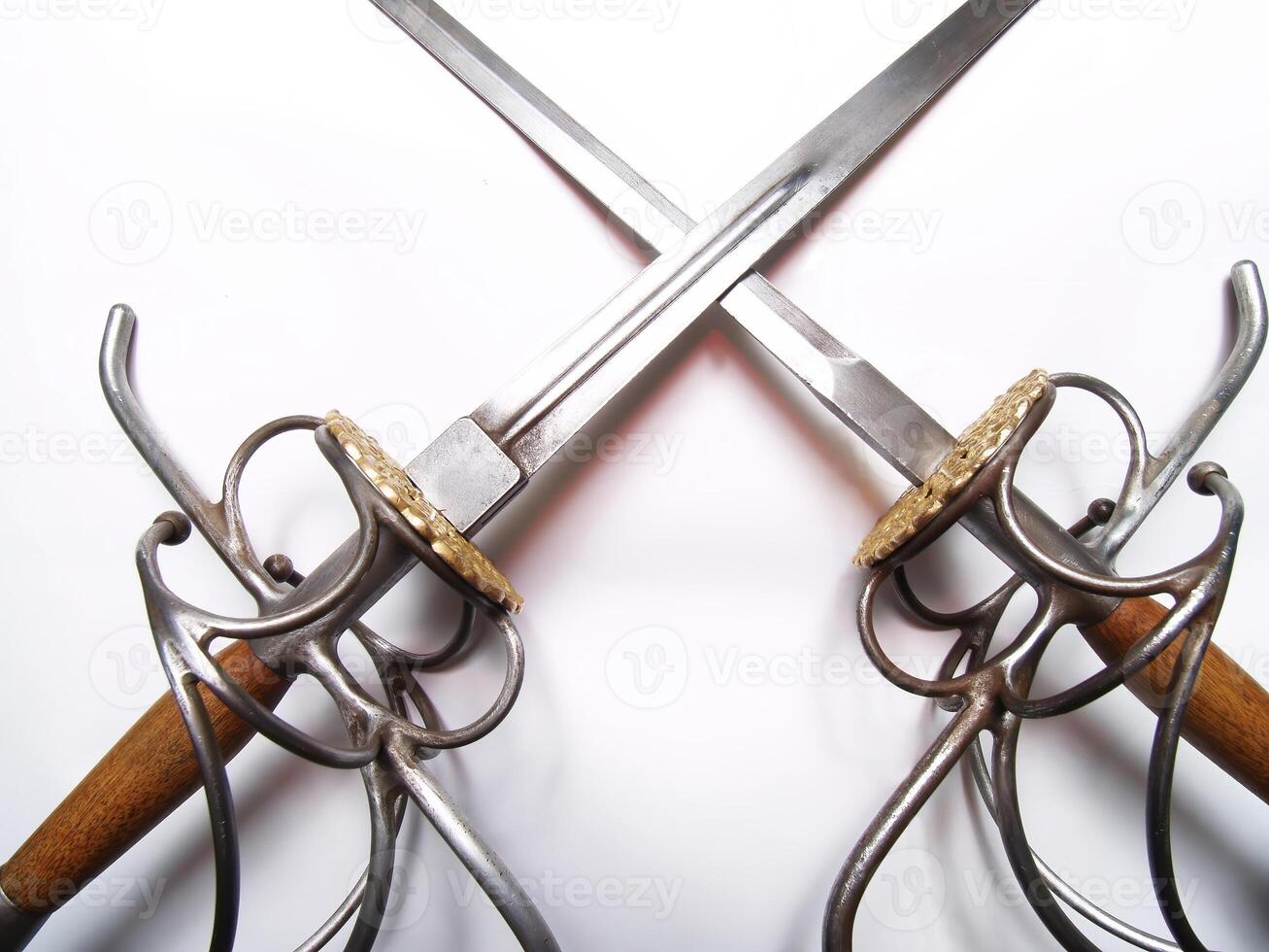 Crossed Sword And Dagger Blades And Hilts On White photo