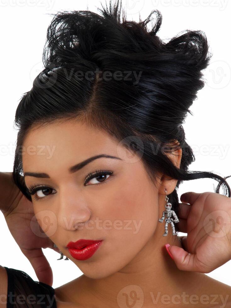 Young hispanic woman portrait with skeleton earrings photo