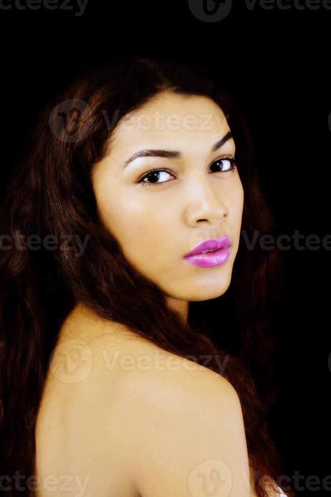 Latina Woman Portrait Looking Over Bare Shoulder photo