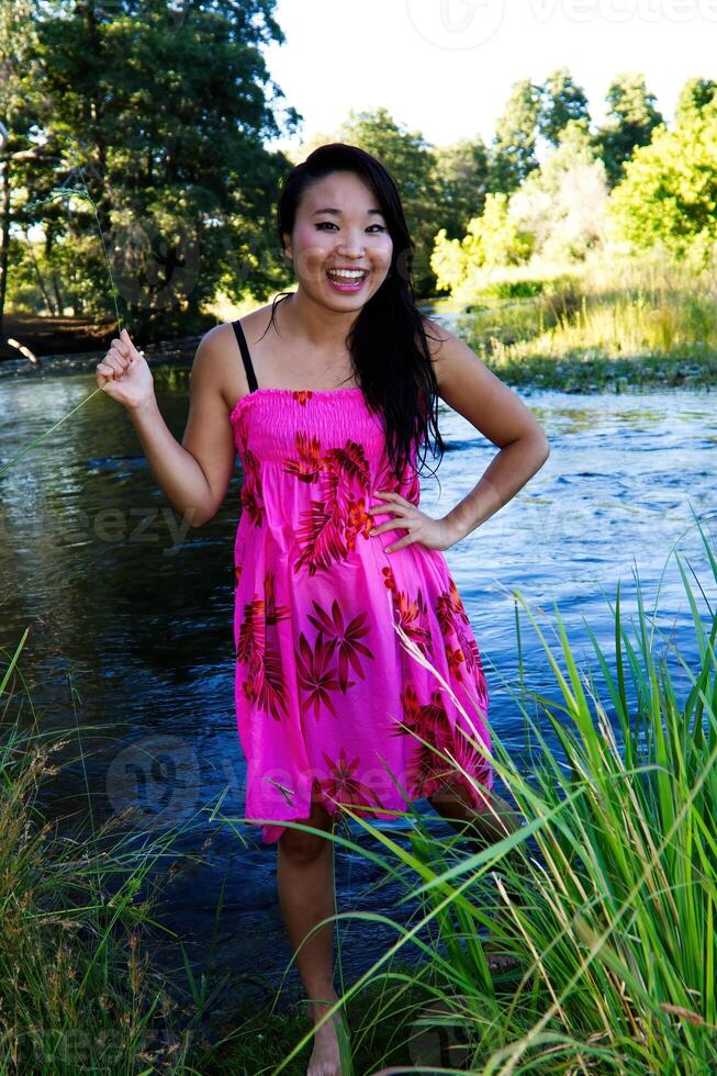 Smiling Japanese American Woman Floral Dress At River photo