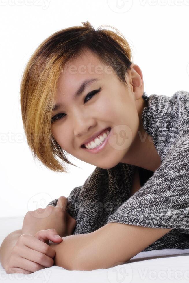 Smiling Asian American Woman On Stomach Short Hair photo