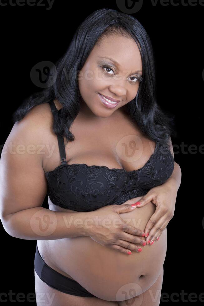 Young pregnant black woman hands on stomach photo