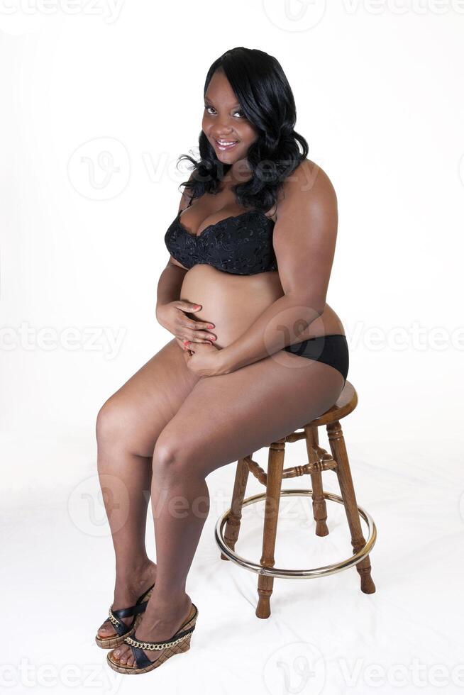 Young Black Pregnant woman holding belly lingerie photo