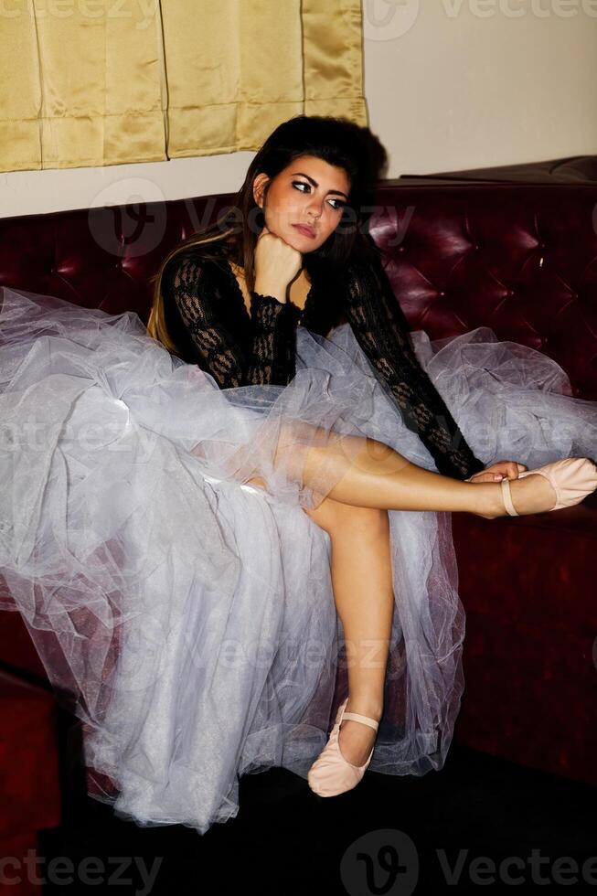 Young Caucasian Woman Sitting In Dance Outfit On Sofa photo