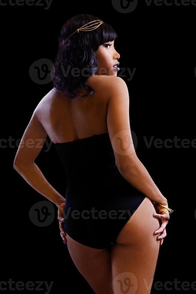 African American Woman In Black Leotard On Dark Background photo