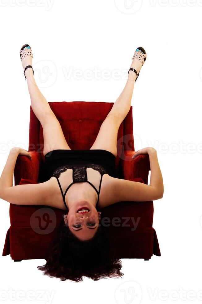 Caucasian Woman In short Black Dress Upside-Down On Chair photo