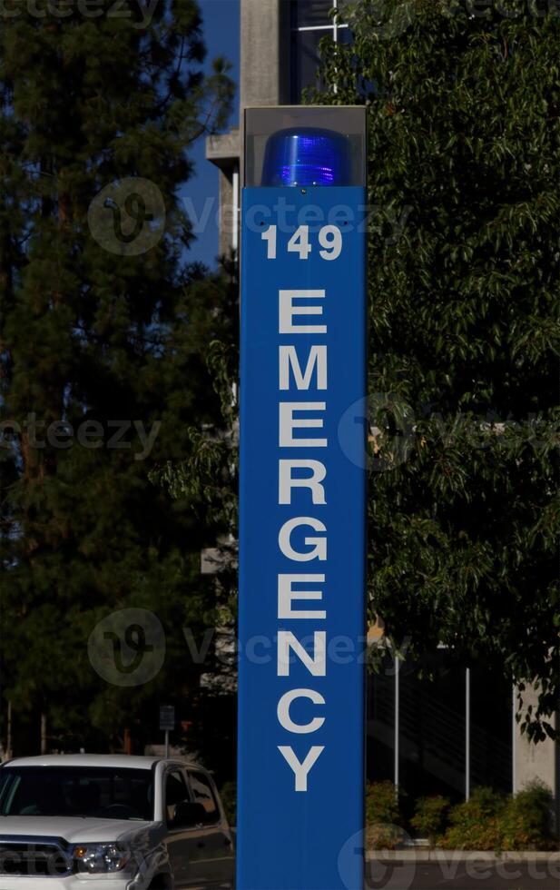 Blue Light Emergency  Call Box Sign With Green Trees photo