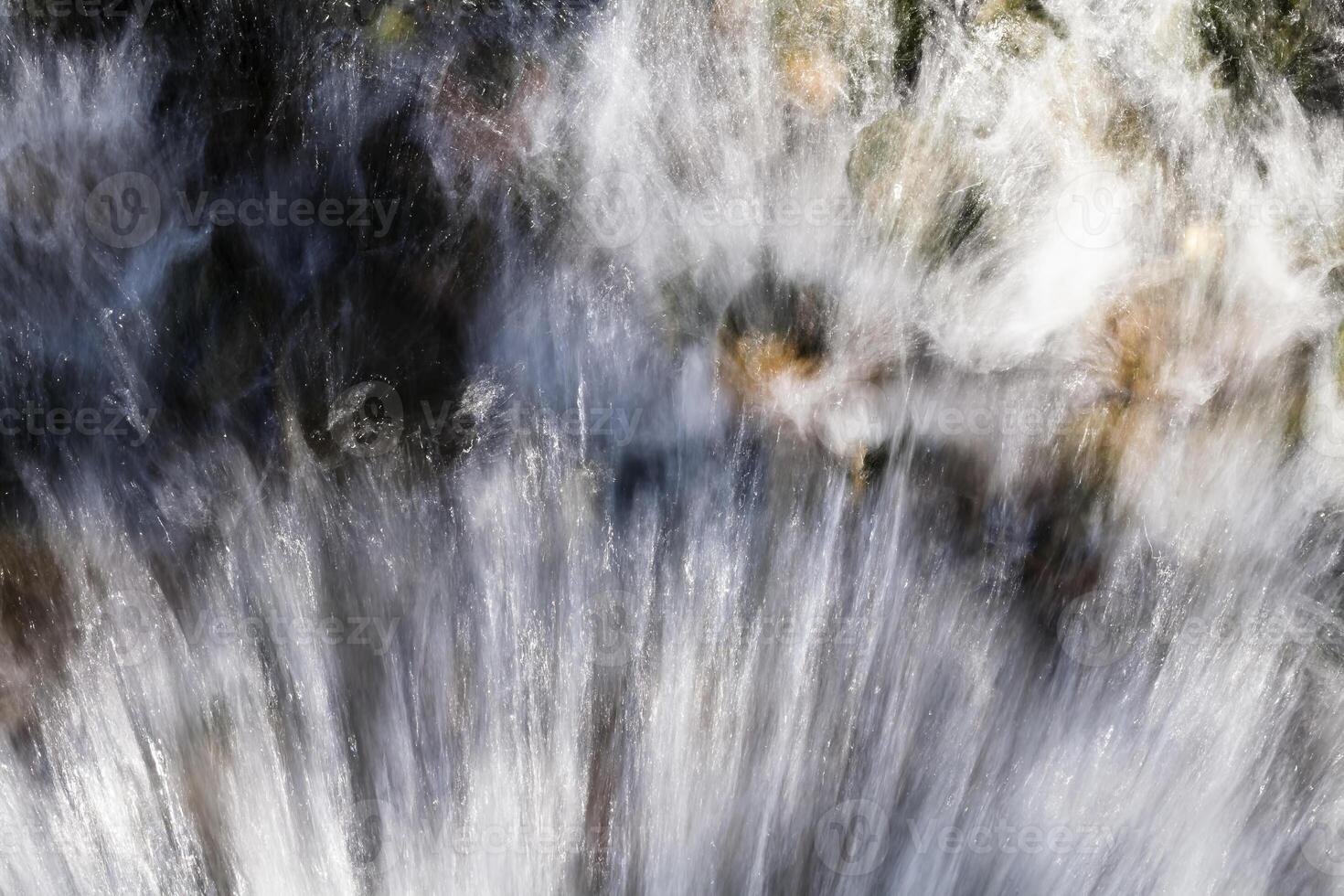 Water Splashing And Spraying Over Rocks Outdoors photo