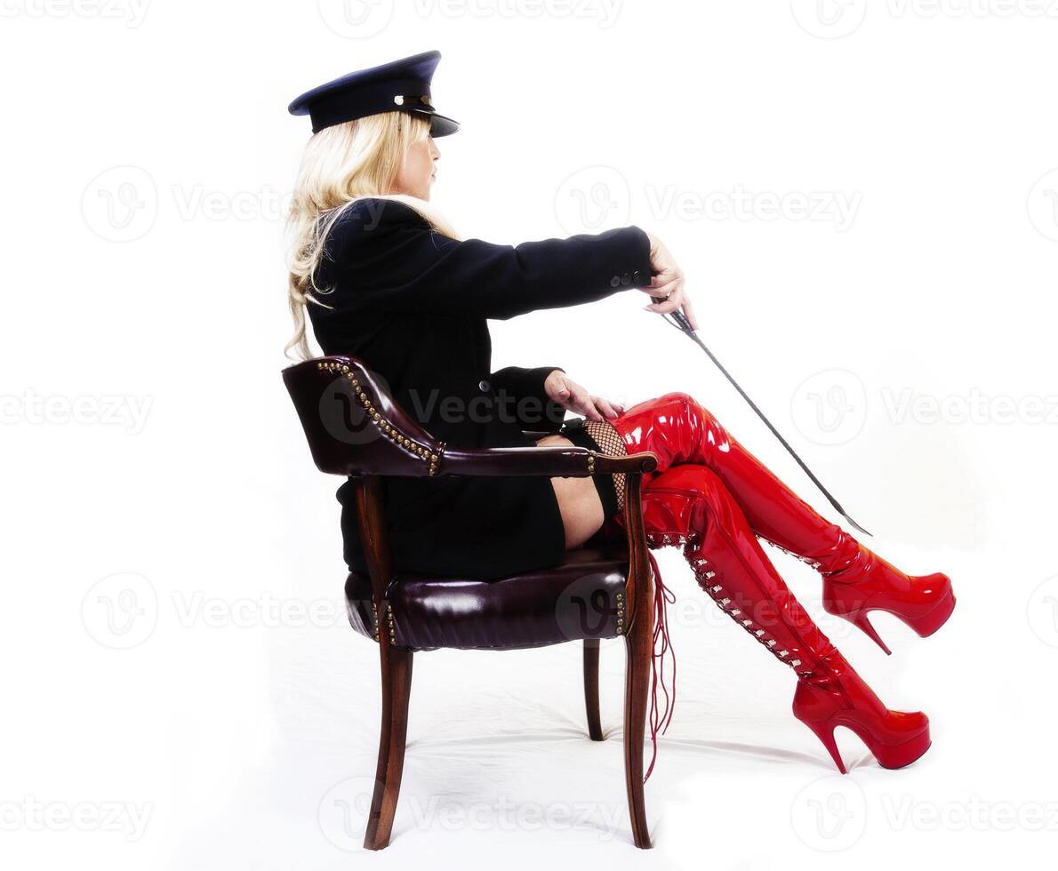 Older Caucasian Blond Woman Boots Jacket Hat Sitting photo