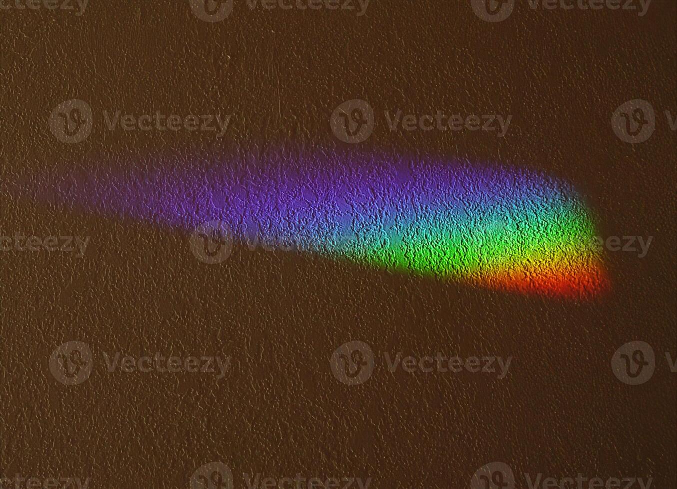 Rainbow From Prism On Textured Wall Indoors photo