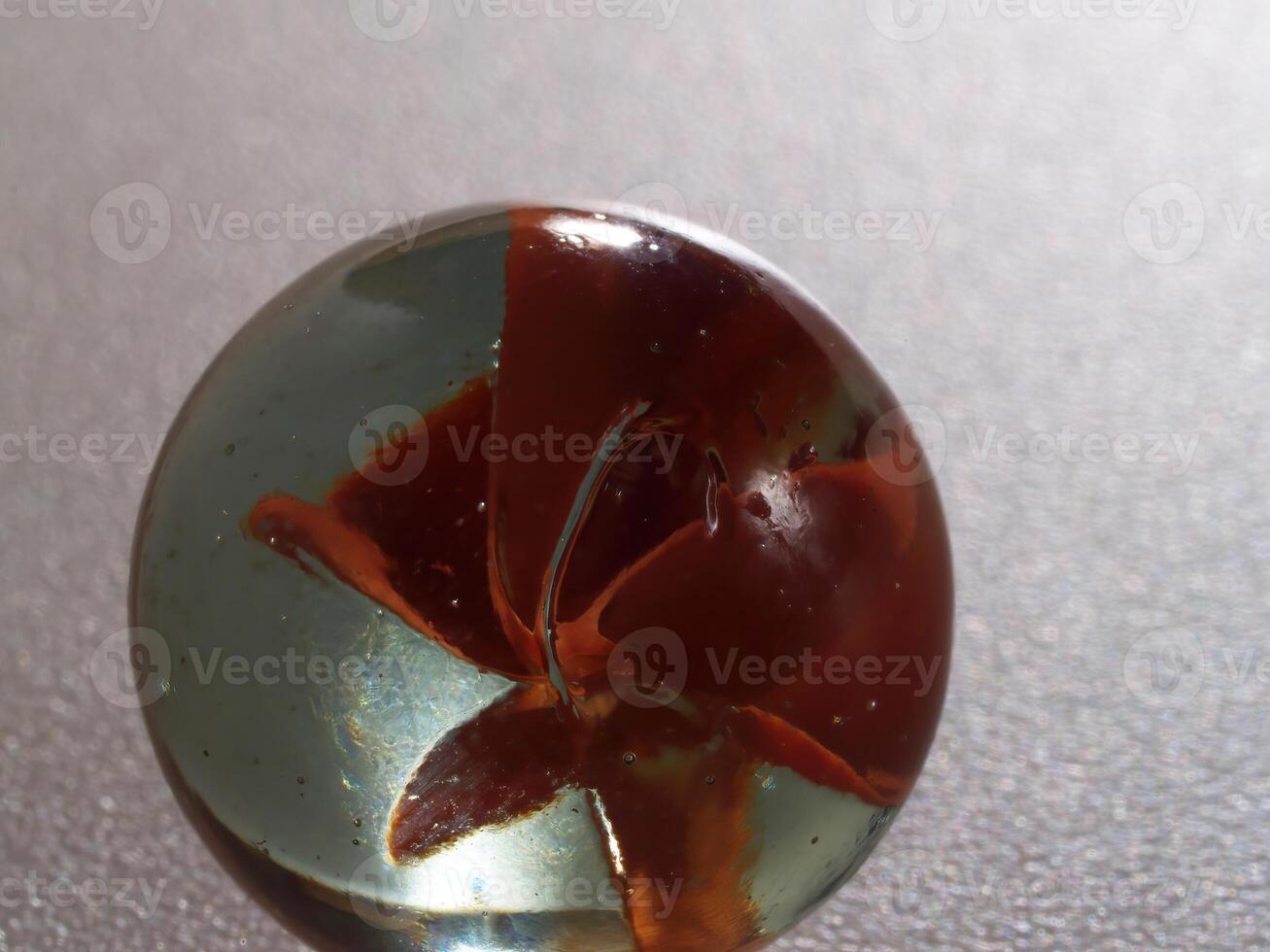 Tight Shot Of A Single Marble On Gray Surface photo
