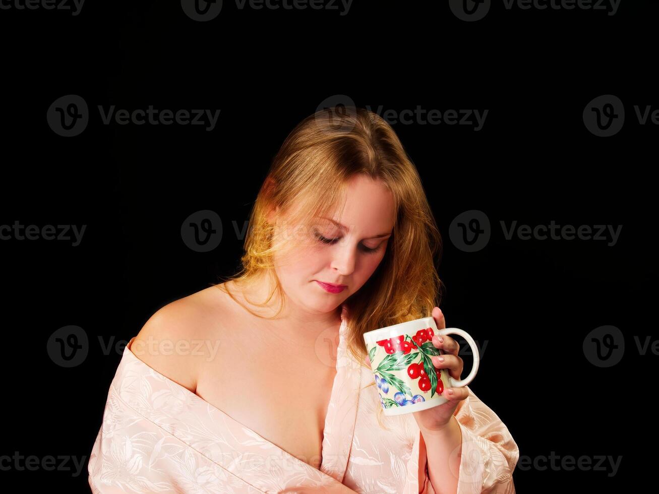 Young Caucasian Woman Wearing Robe Holding Coffee Cup photo