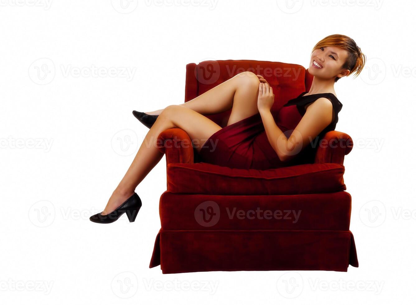 Smiling Asian American Woman Sitting In Red Dress photo