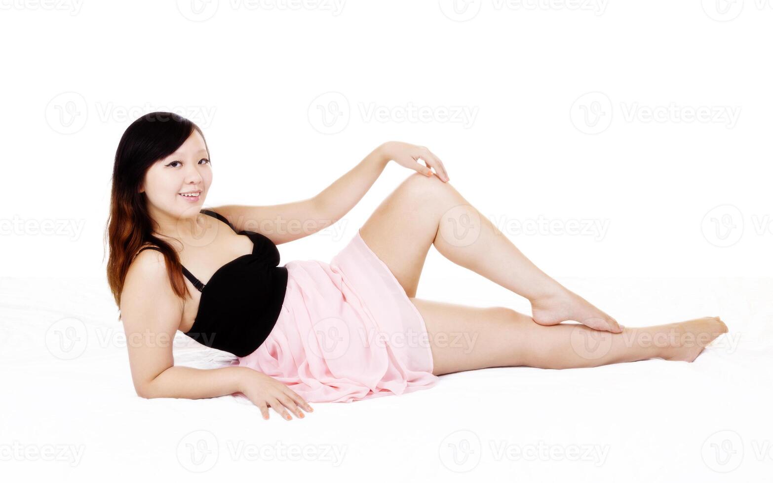 Young Asian American Woman Reclining Pink Dress photo