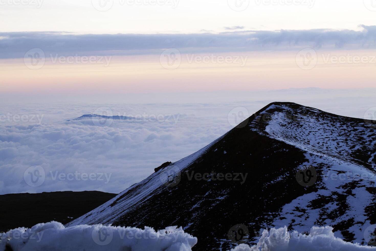 Volcano cone with snow and clouds horizontal photo