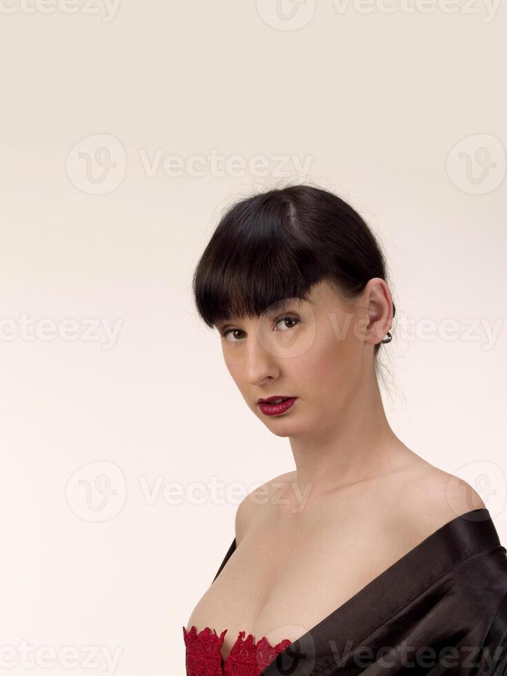 Young Woman in Red Corset and Black Robe photo