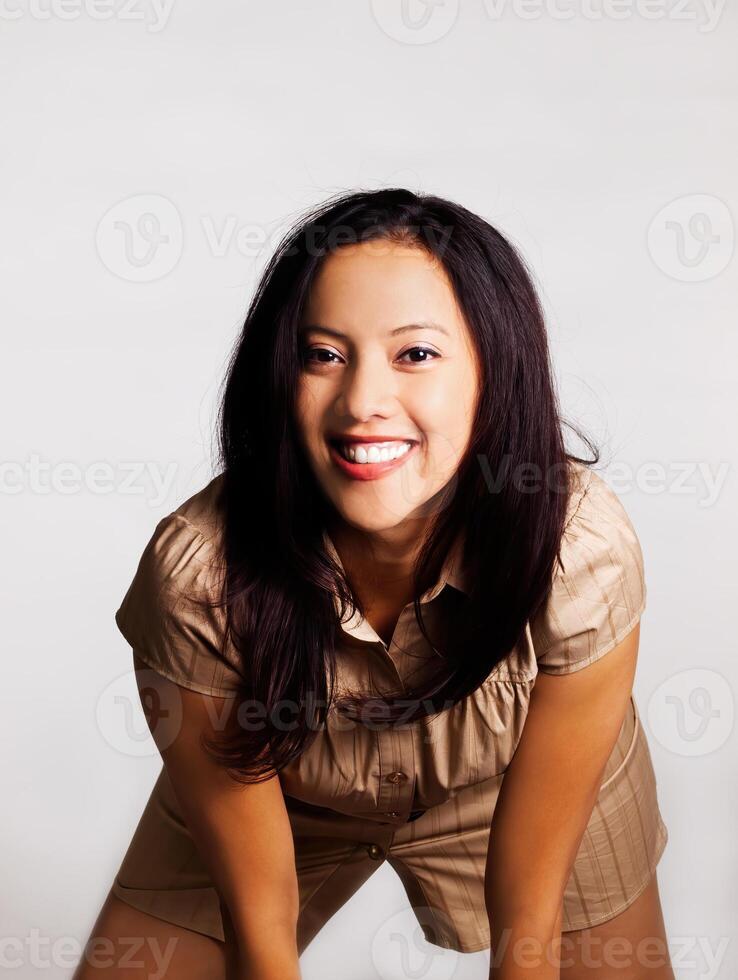 Filipina Woman In Brown Dress Smiling On Gray Background photo