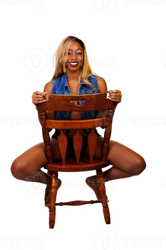 Smiling African American Woman Sitting On Chair Backwards photo