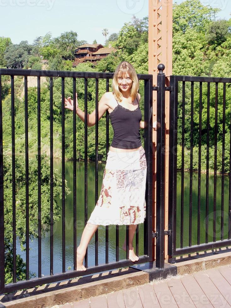 Slim Caucasian Blond Woman on Bridge photo