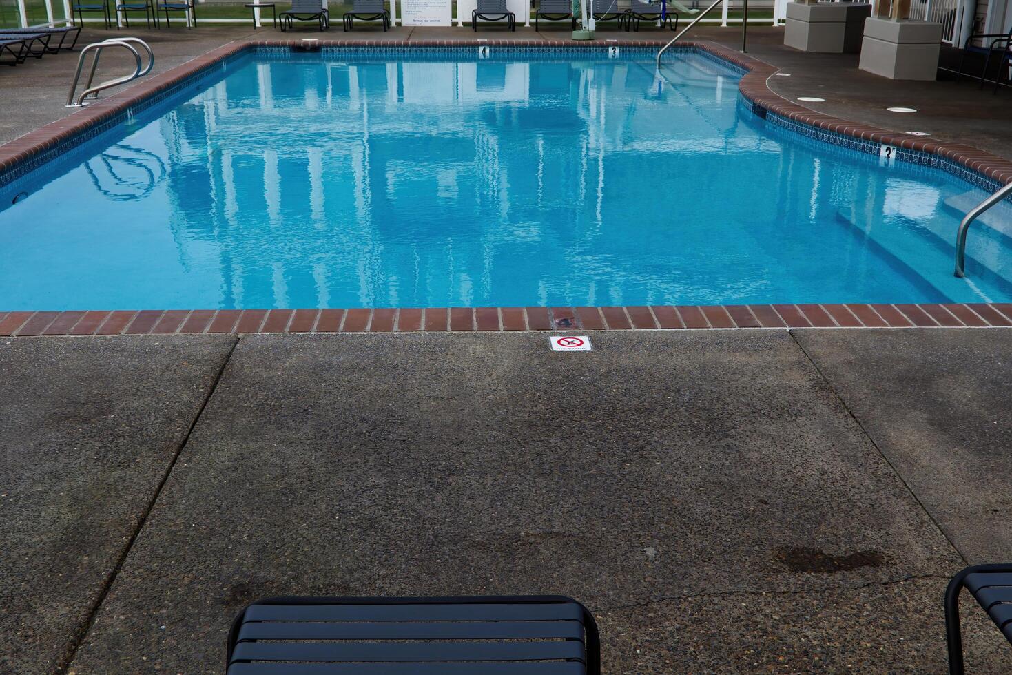 Depoe Bay, OR, 2016 - Empty Swimming Pool With Lounge Chairs Around photo