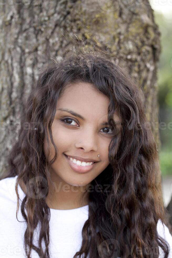 Outdoor portrait pretty young hispanic teen girl photo