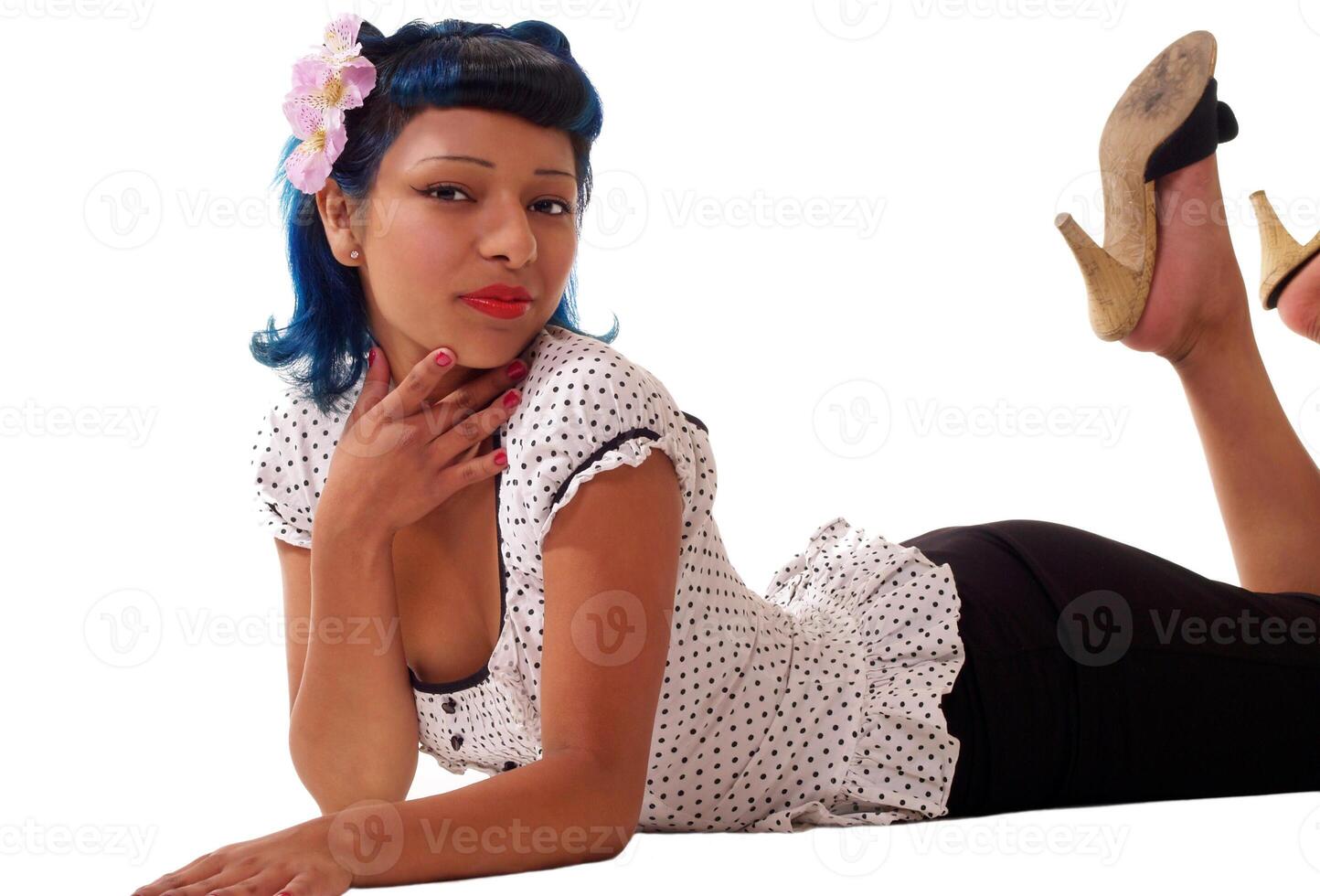 Young hispanic teen woman on floor in skirt and top photo