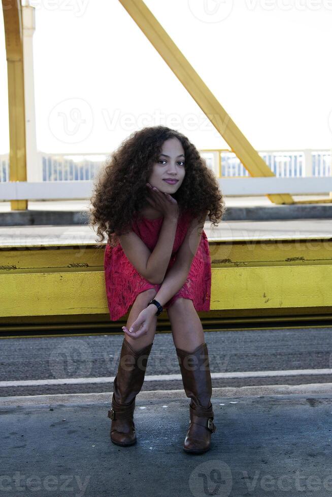 Young Mixed Black Woman Red Dress Sitting photo