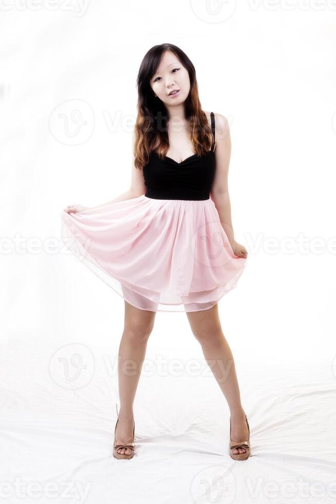 Chinese American Woman Standing In Black And Pink Dress photo