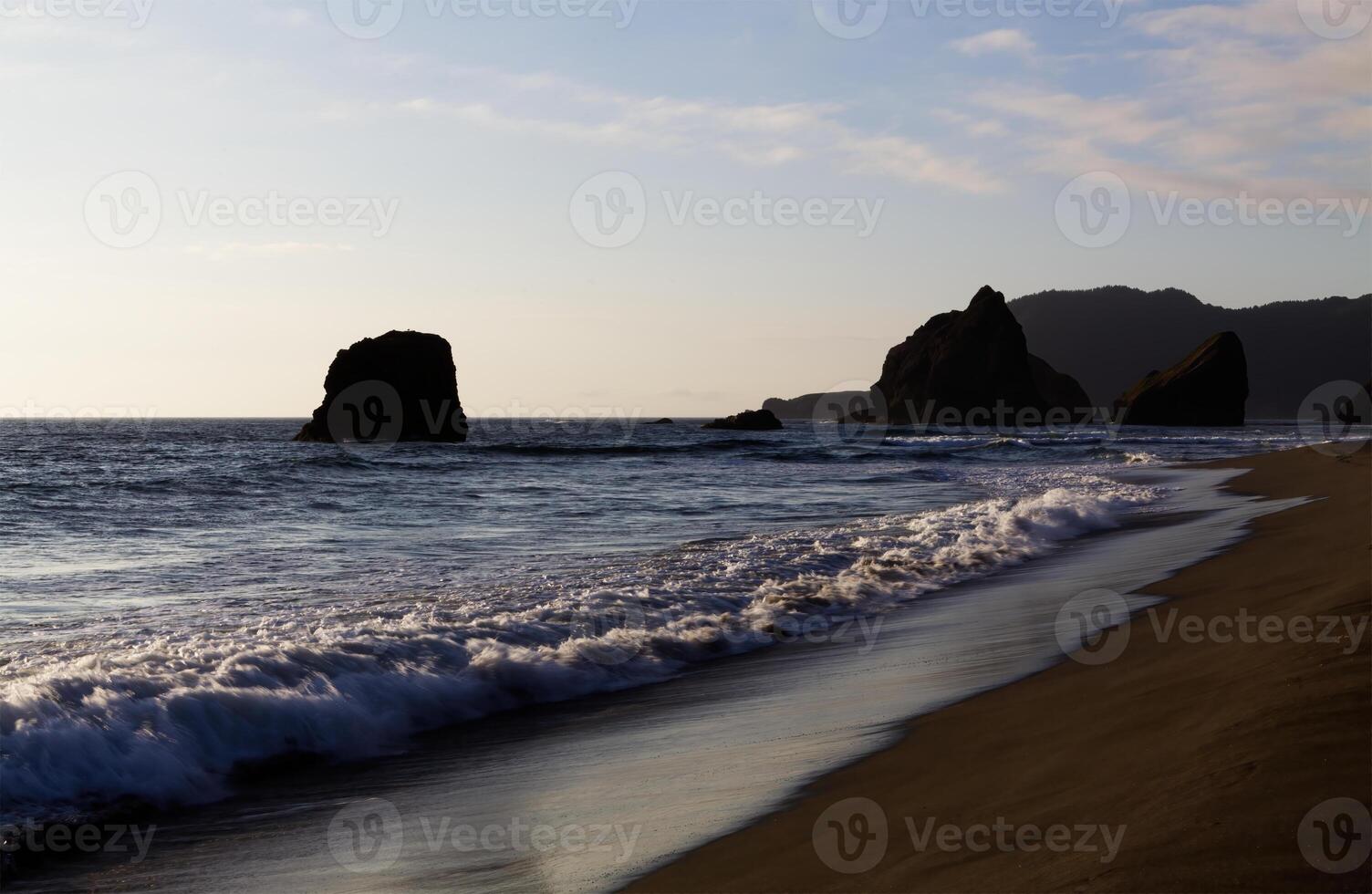 Ocean Waves On Sand Beach With Off Shore Rocks photo