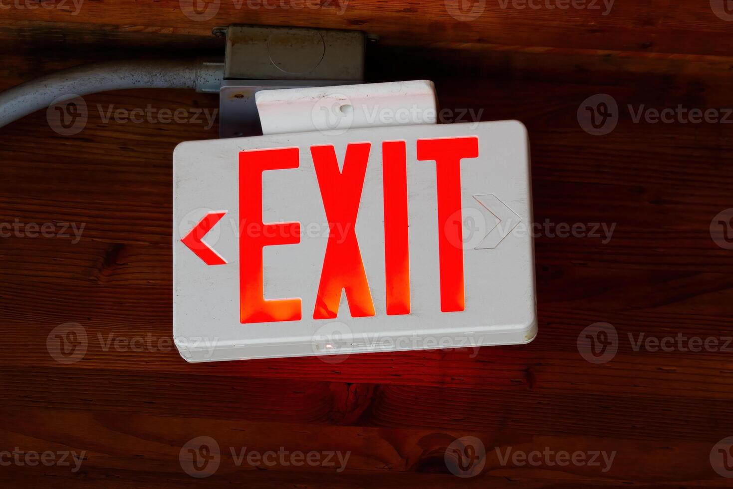 Illuminated Exit Sign With Electrical Box And Wood Beams photo