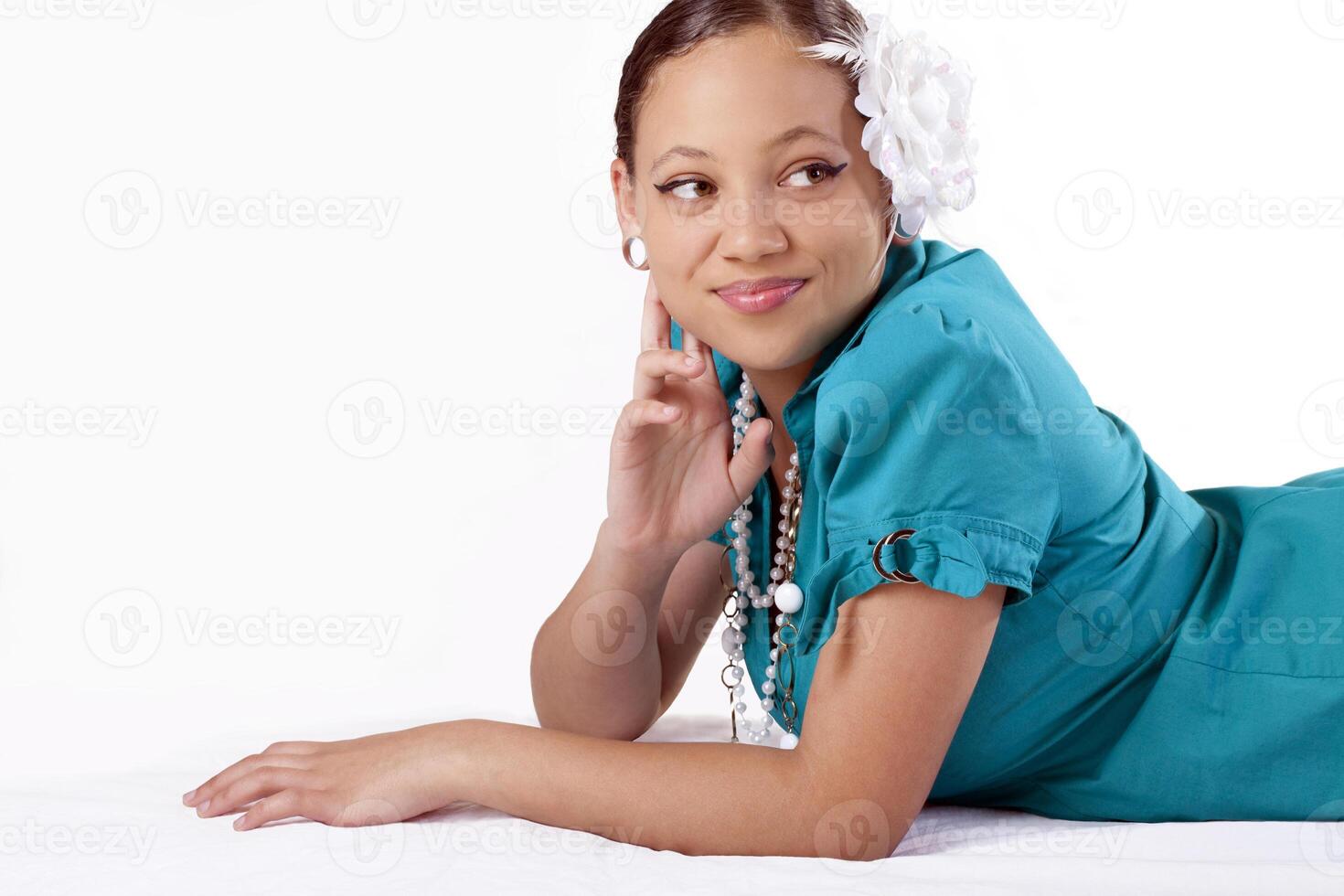 Young mixed ethnic woman reclining on stomach photo