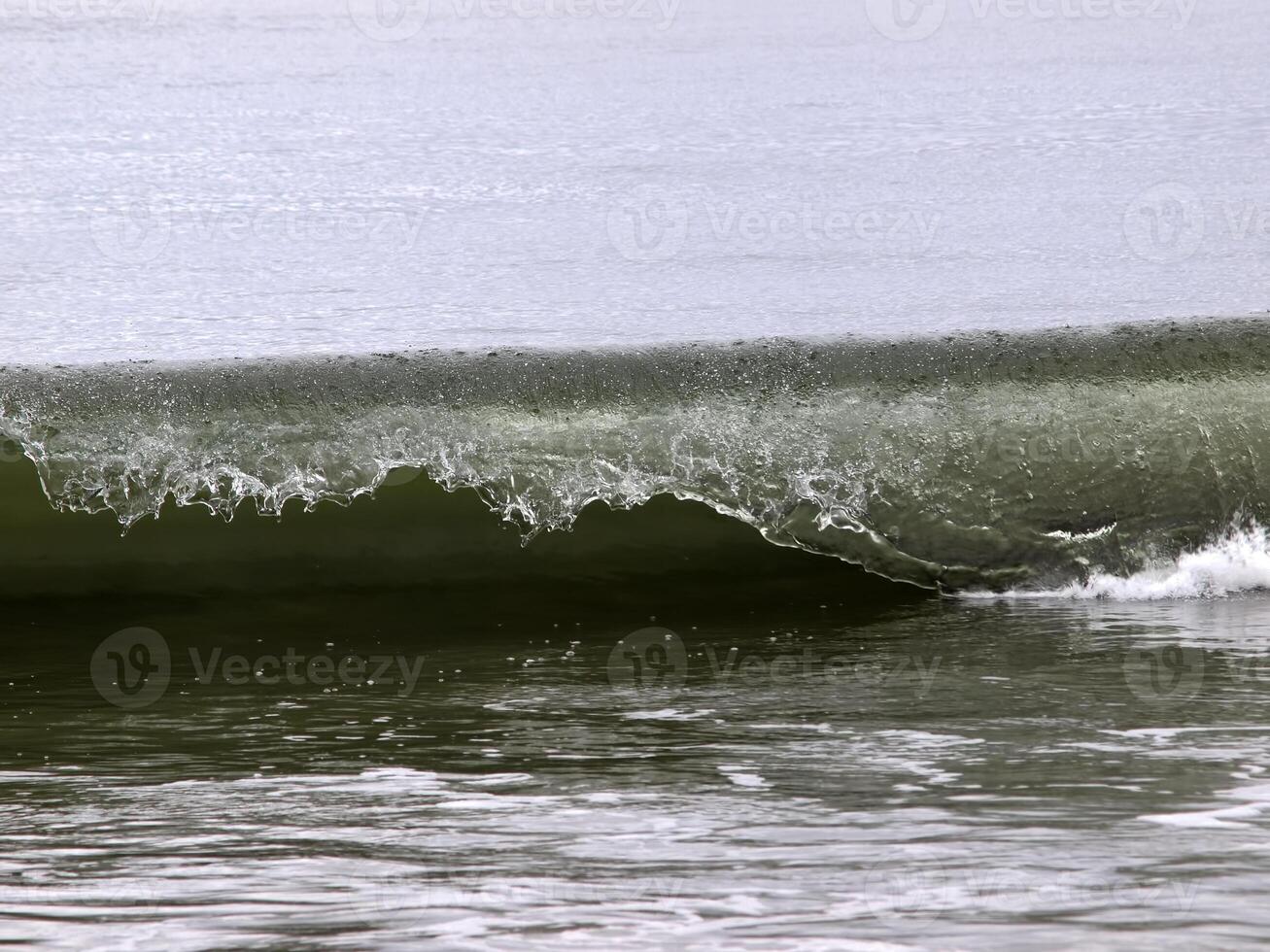 Close Shot Of Ocean Wave Curling Over photo