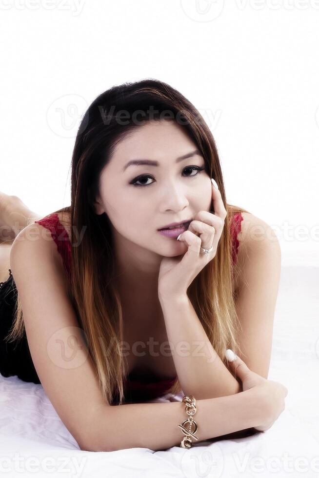 Attractive Asian American Woman On Stomach White Background photo