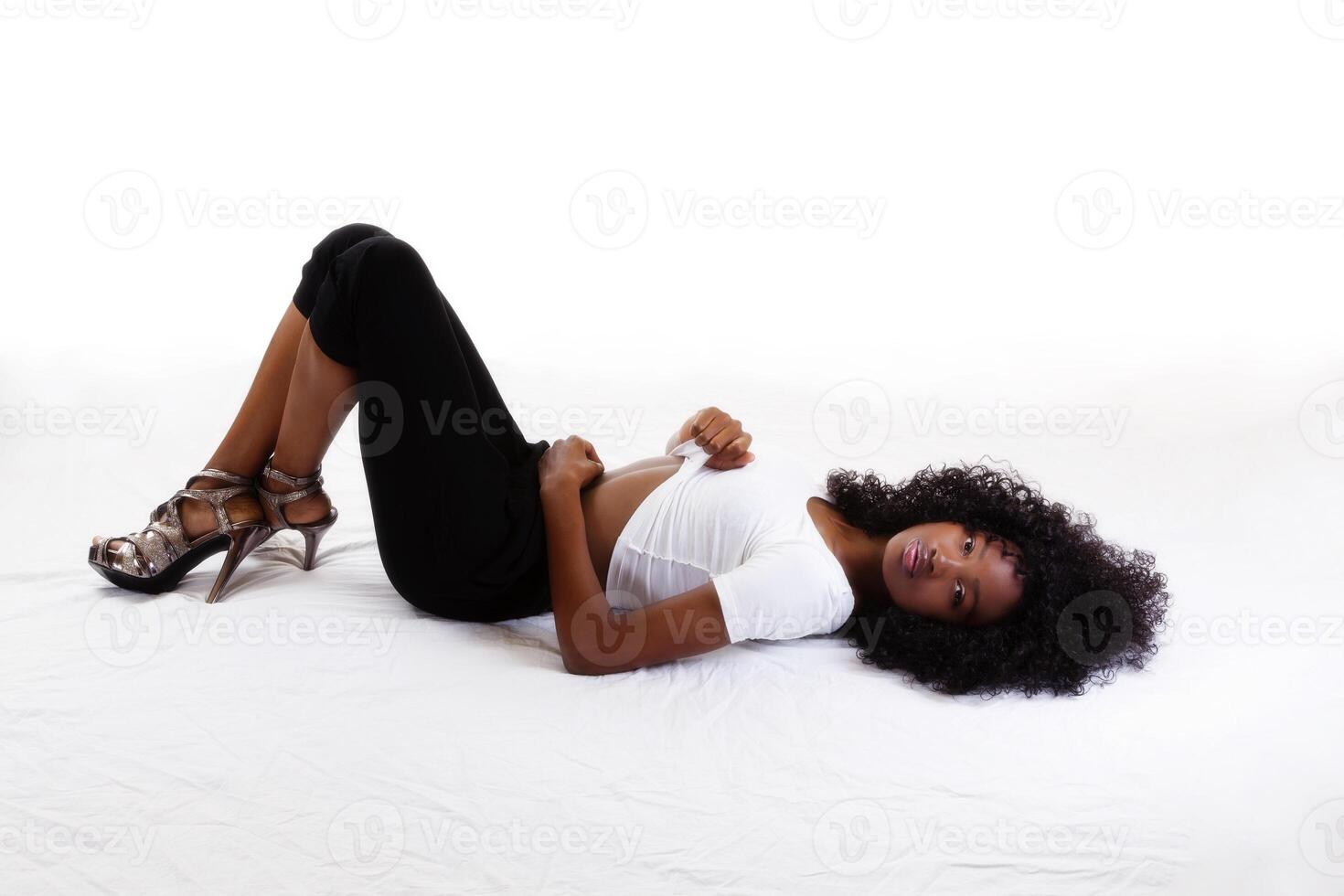 Skinny Black Teen Girl Reclining On Back photo