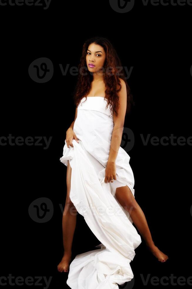 Latina Woman Standing Wrapped In White Sheet photo