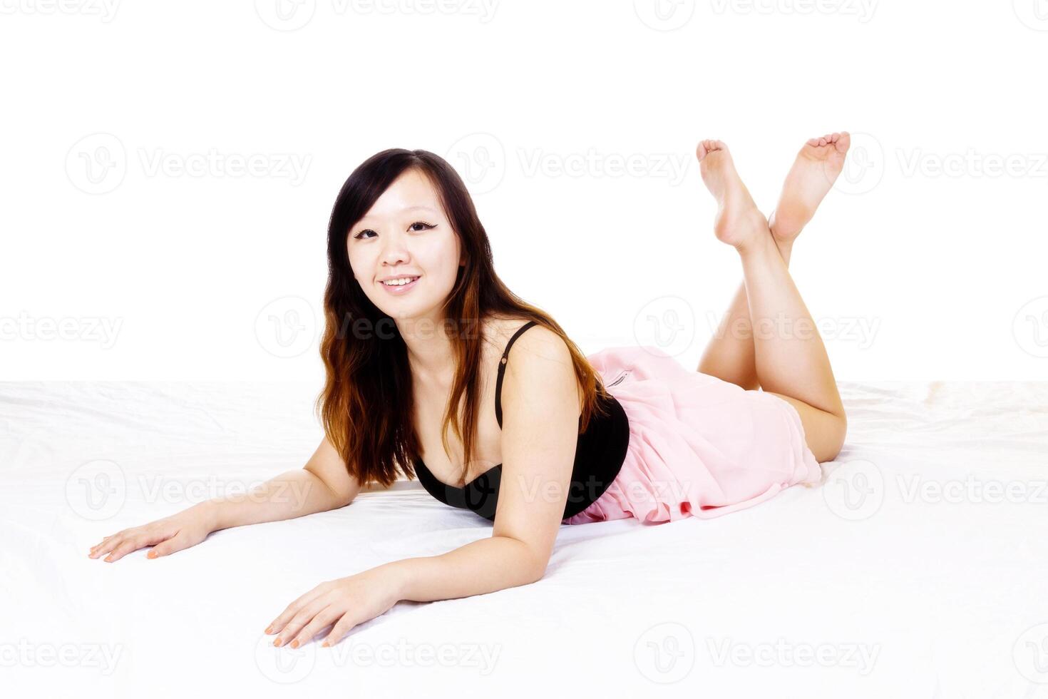 Young Chinese Woman Pink And Black Dress Reclining photo