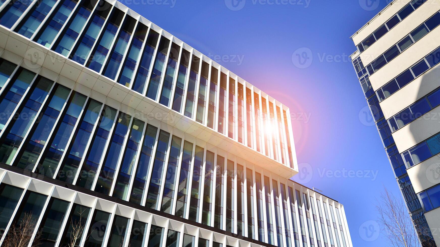 Modern office building in the city with windows and steel and aluminum panels wall. Contemporary commercial architecture, vertical converging geometric lines. photo