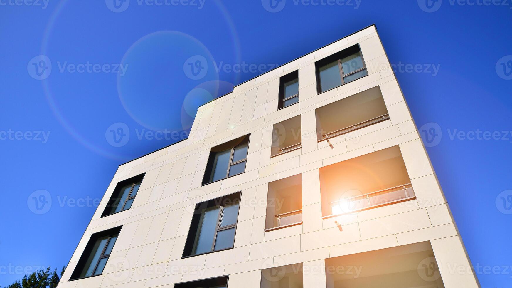 View of a white modern apartment building. Perfect symmetry with blue sky. Geometric architecture detail modern concrete structure building. Abstract concrete architecture. photo