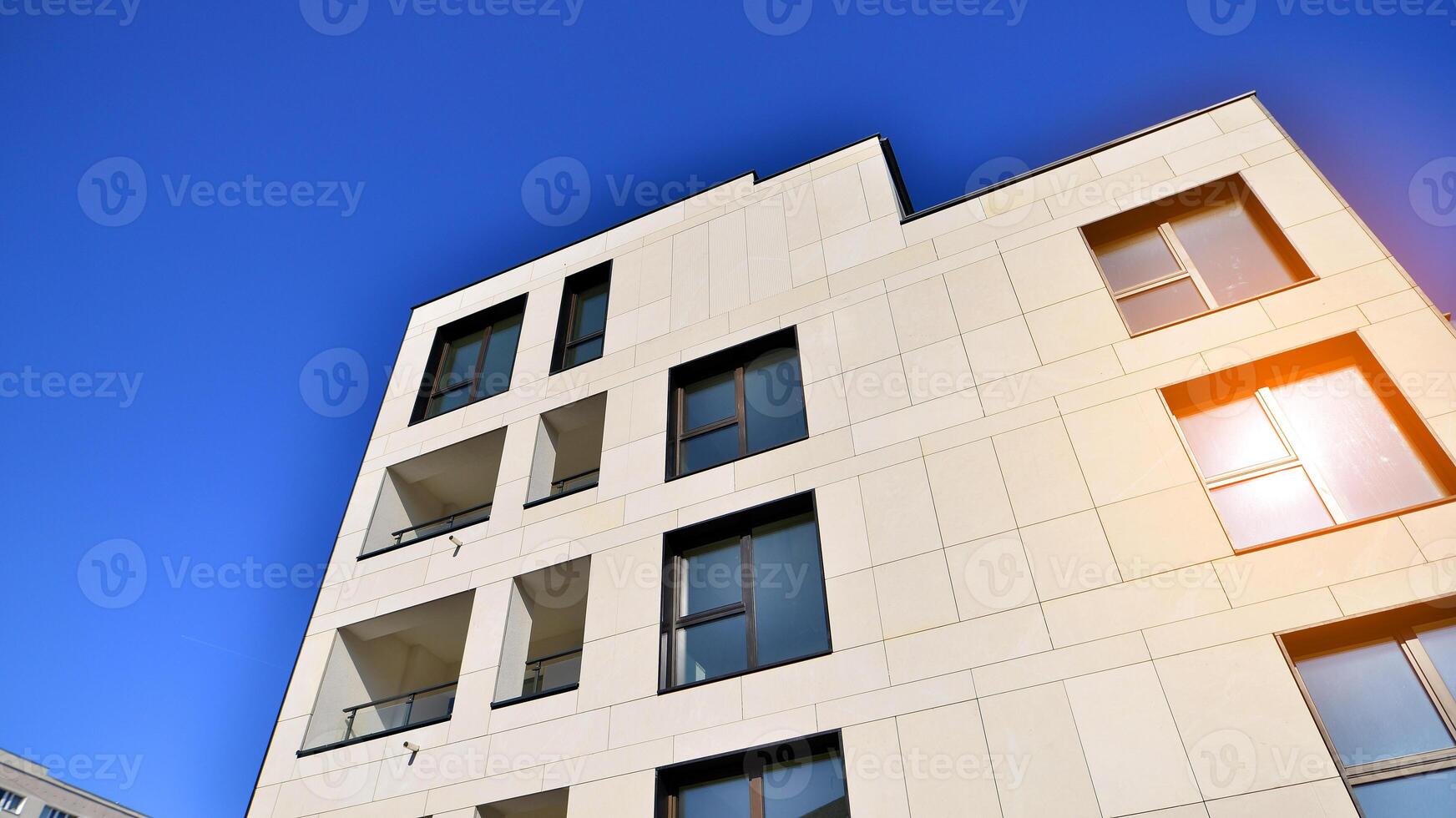 View of a white modern apartment building. Perfect symmetry with blue sky. Geometric architecture detail modern concrete structure building. Abstract concrete architecture. photo