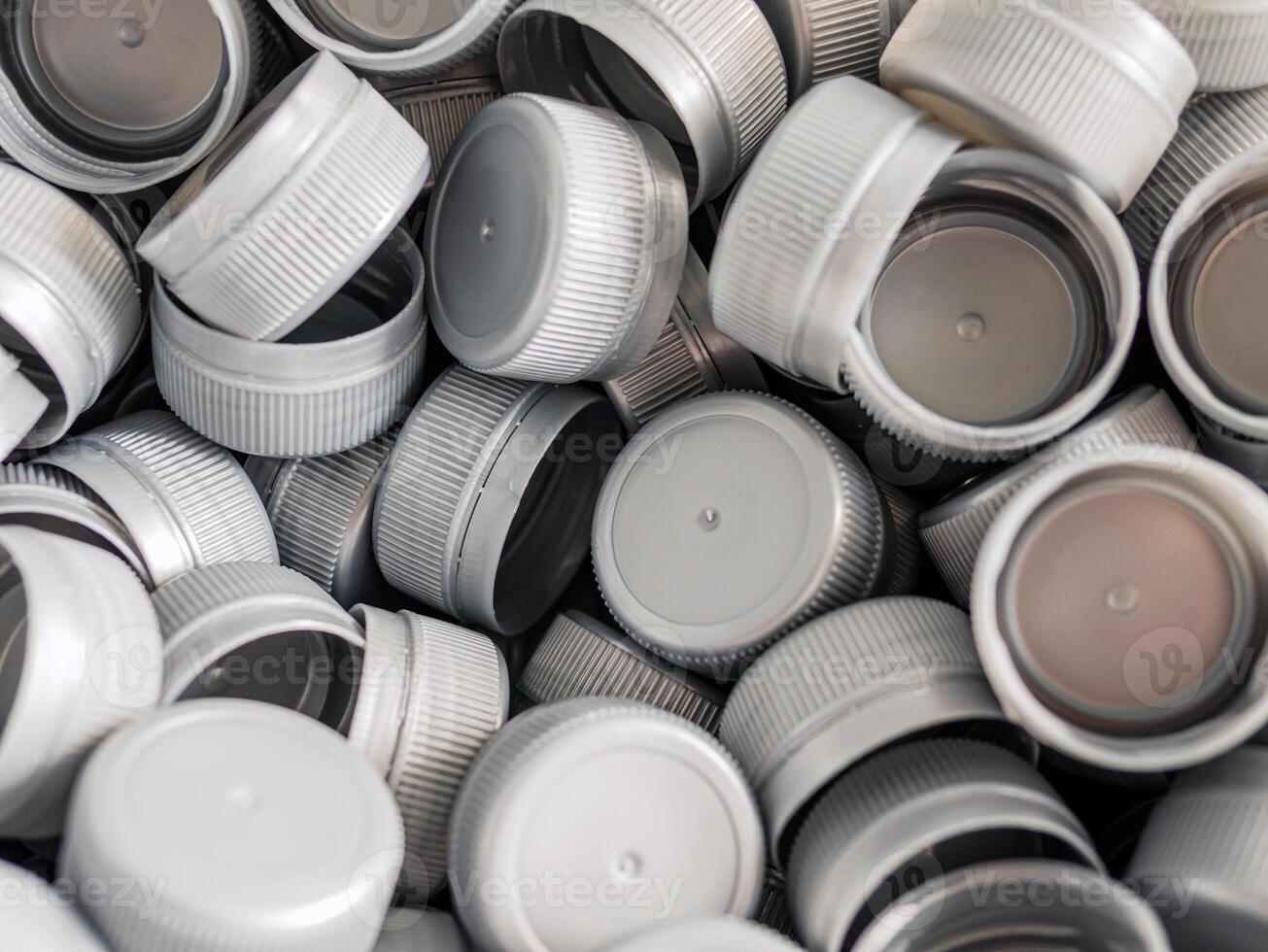 Top view grey plastic bottle caps.Recycling collection and production processing plastic bottle caps background photo