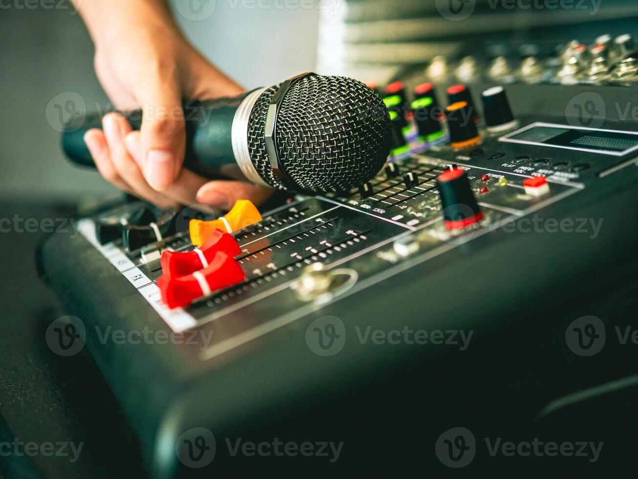 Hand Sound engineer  holding microphone on sound mixer in live broadcasting studio producer for sound record control system production and audio equipment and music instrument photo