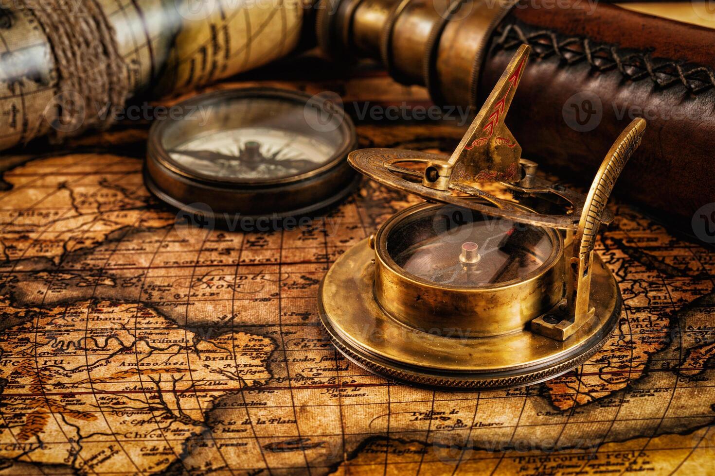 Old vintage compass on ancient map photo