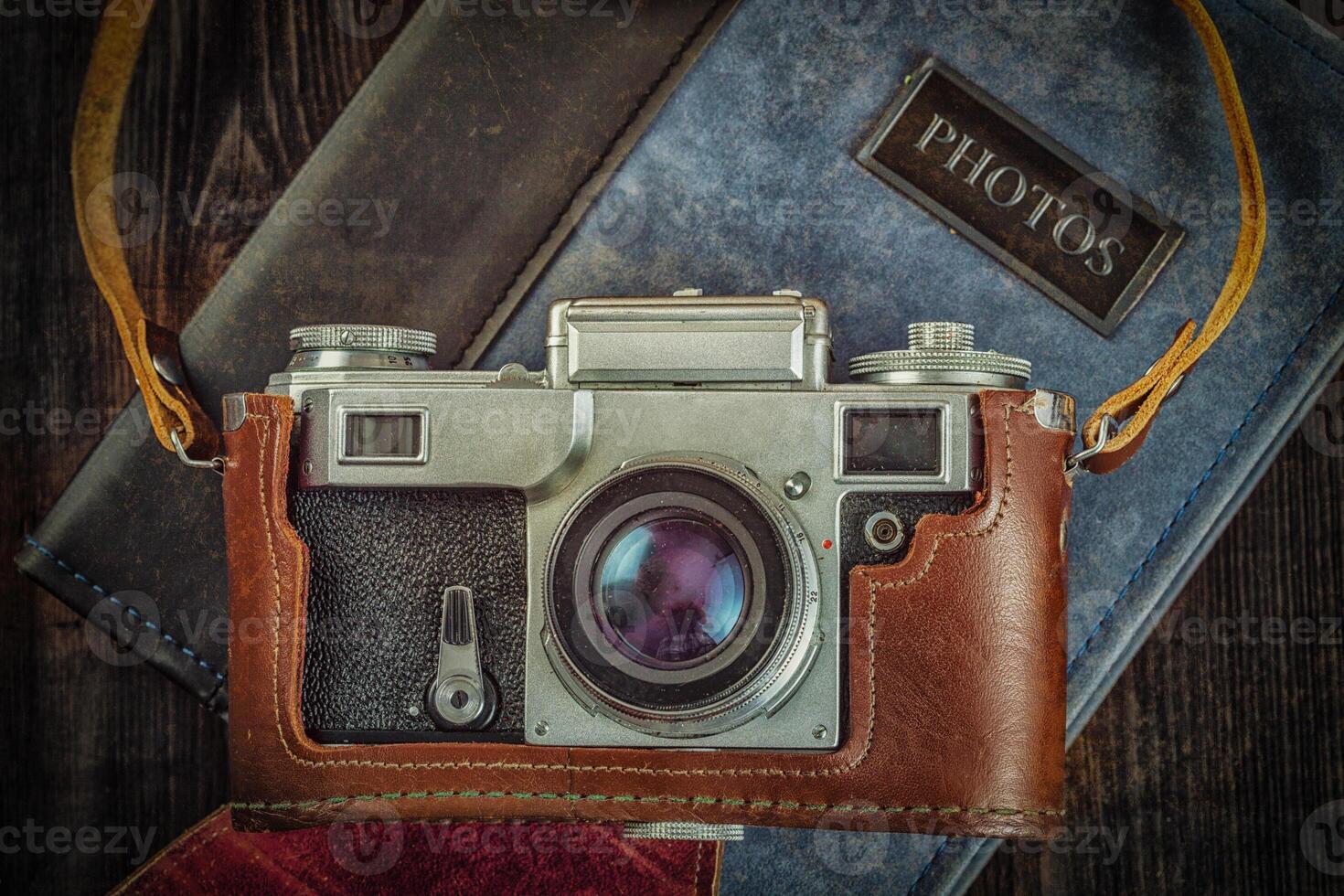 Old retro vintage camera on grunge wooden background photo