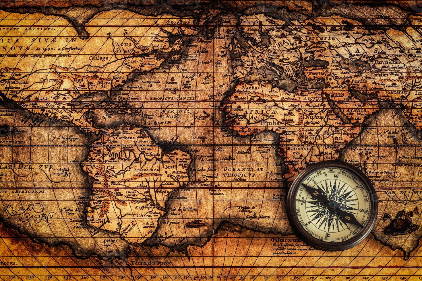 Old vintage compass on ancient map photo