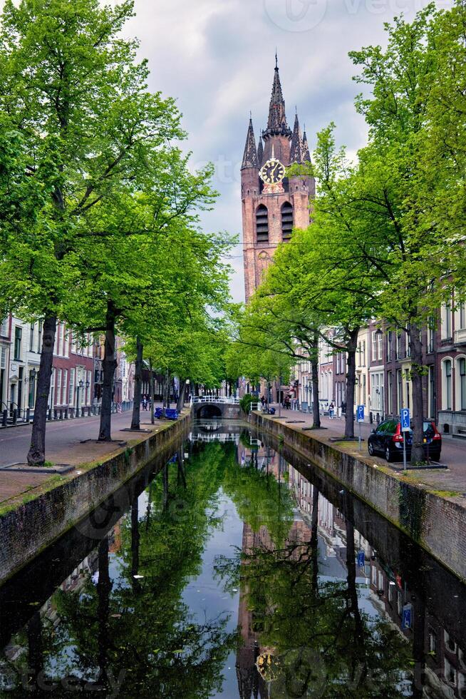 Delt canal with bicycles and cars parked along. Delft, Netherlands photo